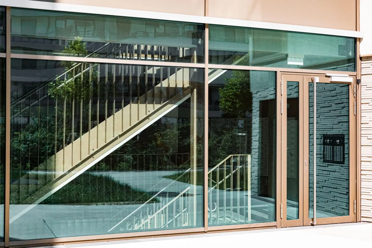A broad glazed entrance in a modern building facade.